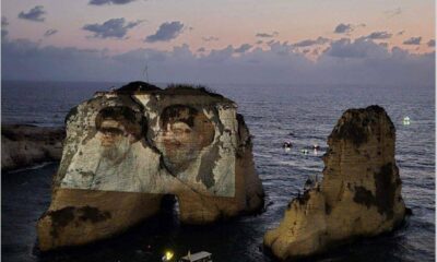 حزب الله يضيء صخرة الروشة بصور نصرالله وصفي الدين